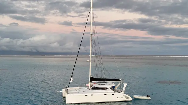 Evening drone panorama of Mā Tori anchored on the reef flats