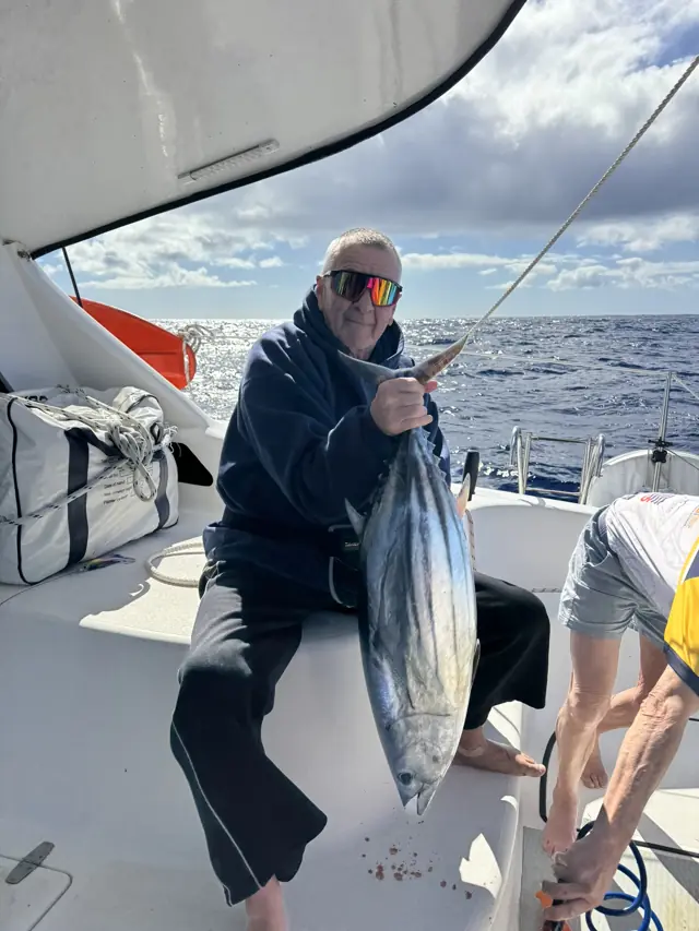 Fresh catch held up in the cockpit offshore