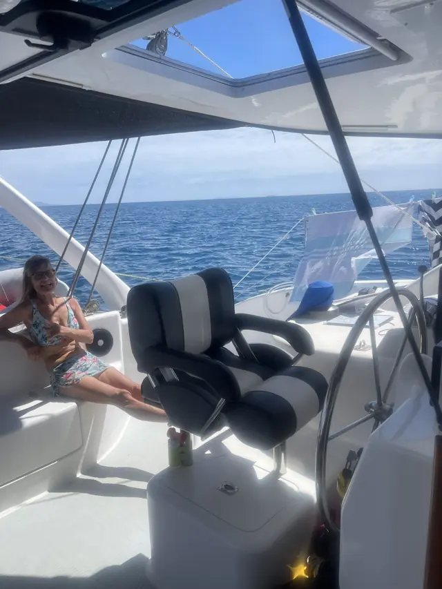 Lounging on the foredeck seen through the saloon hatch