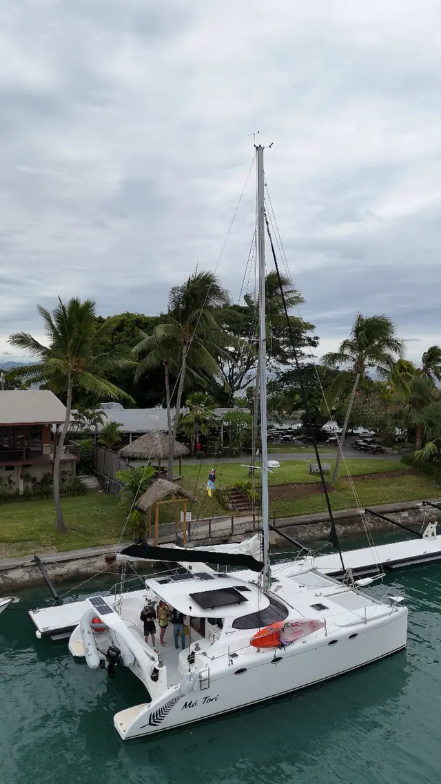 Mā Tori moored beneath palm trees in Fiji