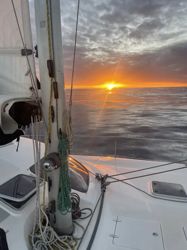 Sunset over the Pacific from the deck of Mā Tori on passage