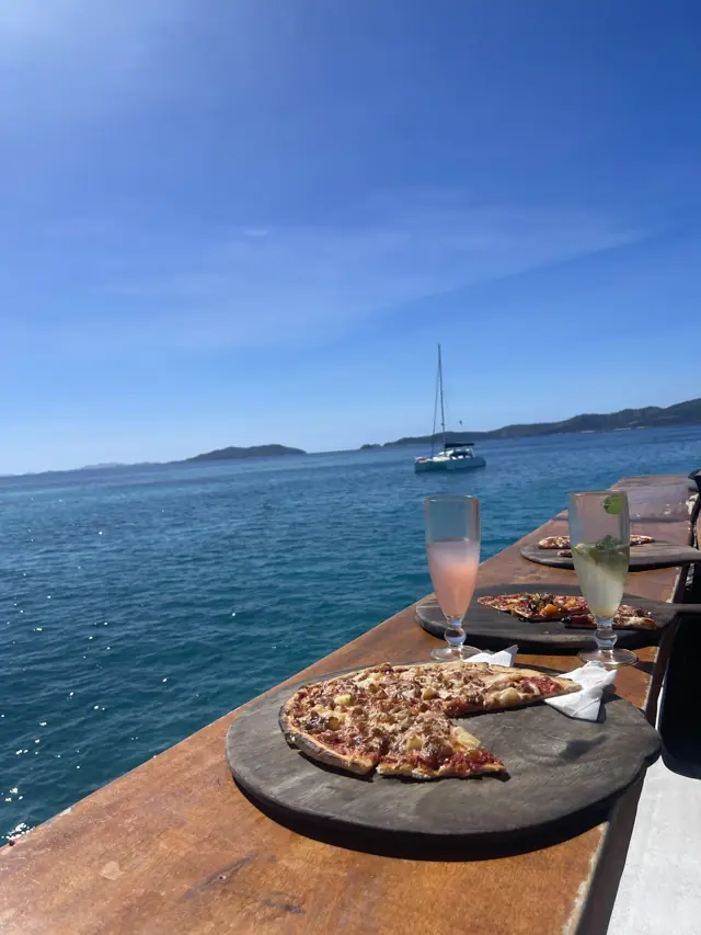 Pizza and drinks overlooking a Fijian anchorage
