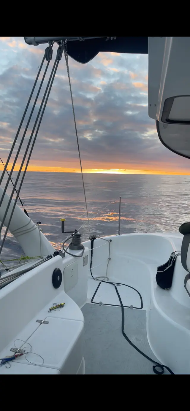 Fishing rods set as the sun goes down on passage