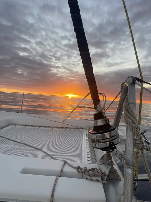 Sunset over the foredeck and winch of Mā Tori