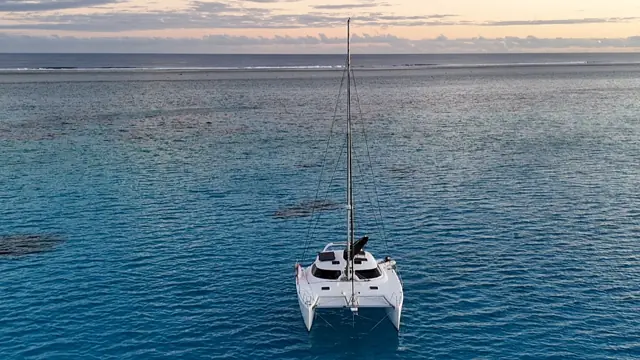 Top-down aerial of the Fusion 40 over reef and turquoise water