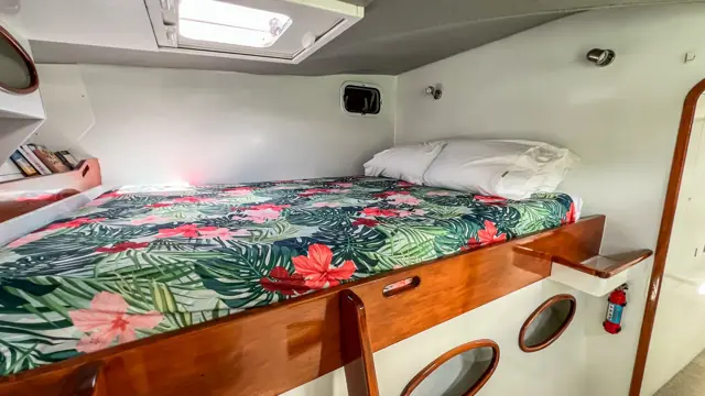 Guest cabin with queen berth in the starboard hull