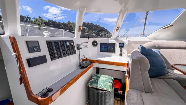 Navigation station with switch panels aboard Mā Tori